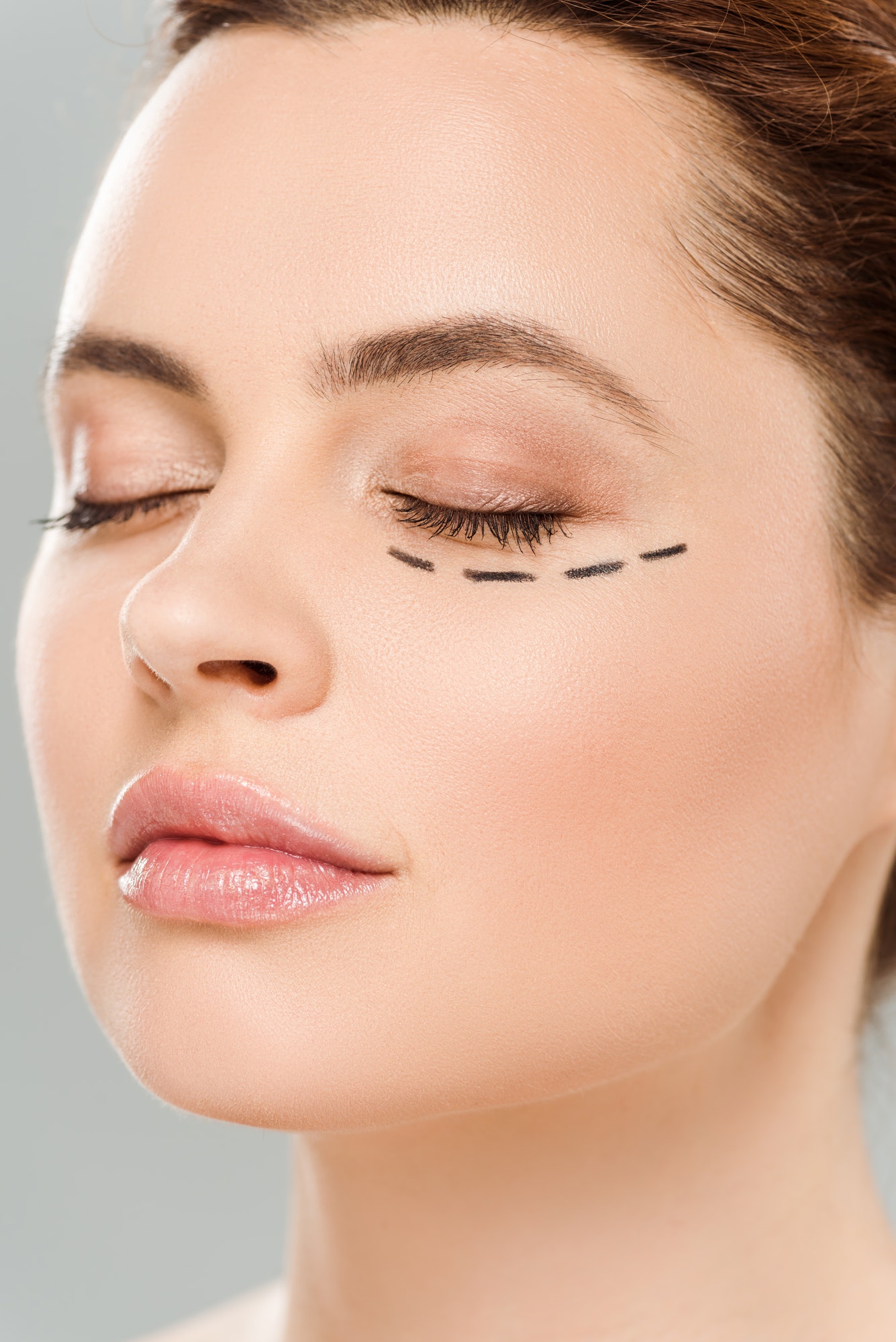 close up view of beautiful woman with closed eyes and marks on face isolated on grey